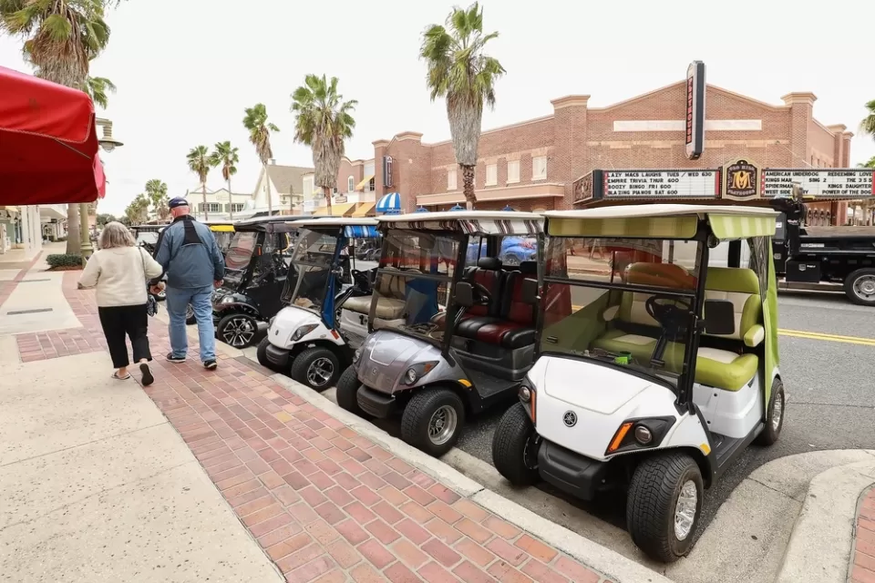 Line of golf carts parked on street in The Villages, Florida